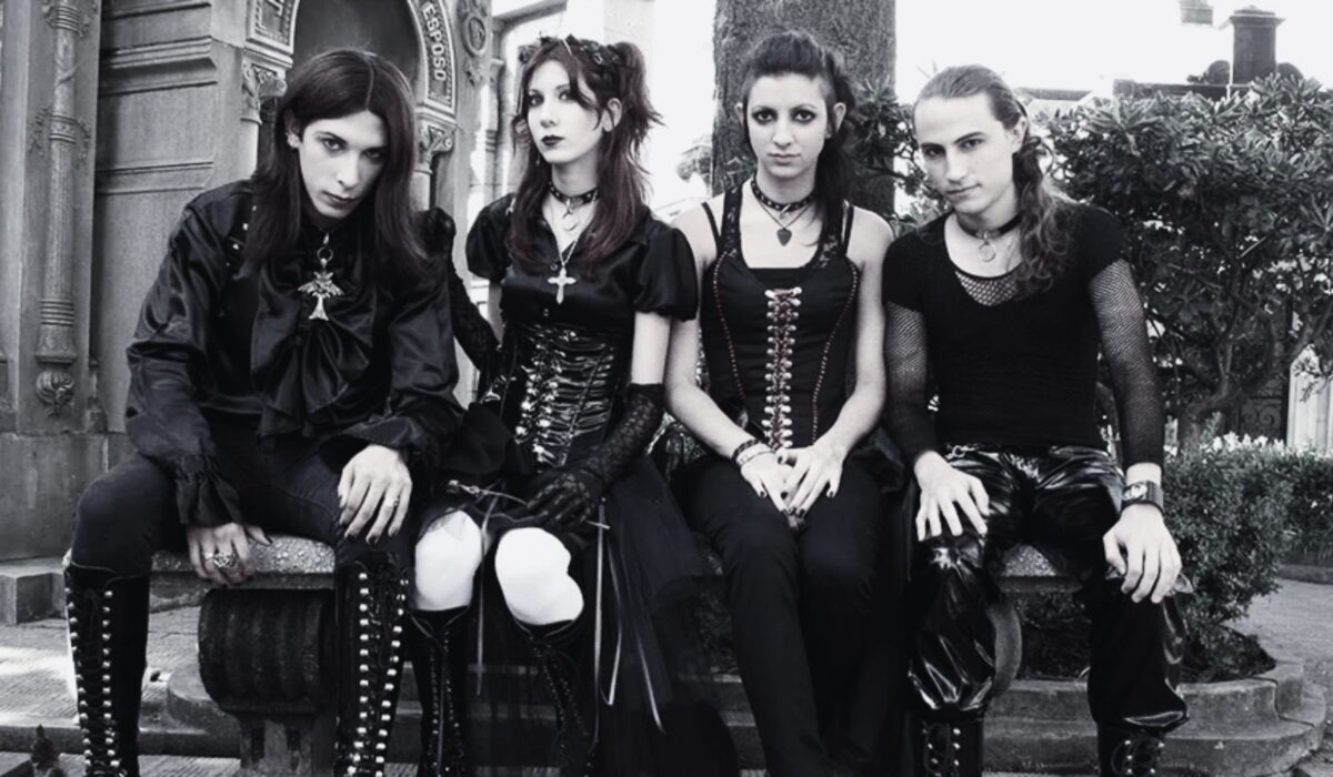 Trad goth fashion look with black high-waisted pants, corset, and dark makeup inspired by 80s goth aesthetic